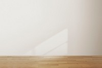 Empty minimal room with natural light on white wall