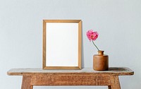 Frame with flowers against blue minimal wall