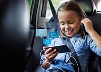 Little girl using a phone in a car