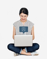Happy Asian woman using her laptop