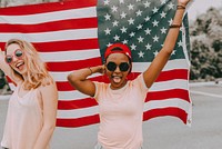 Women celebrating Independence Day, holding American flag