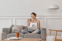 Woman reading while having tea in the living room, hobby photo
