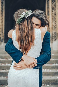 Groom hugging bride, wedding aesthetic rear view photo