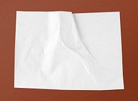 White crinkled paper on brown background