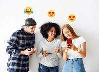 Happy teenagers sharing media through their smartphones