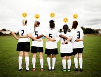 Female soccer players with emoticons standing together