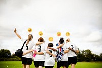 Cheerful female football players huddling