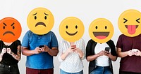 Diverse people with emoticons using mobile phones