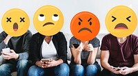 Diverse people with negative emoticons using mobile phones