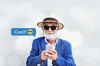 Stylish elderly man texting on his smartphone