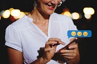 Happy woman texting at night