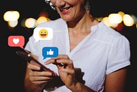 Happy woman texting at night