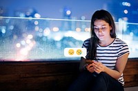 Young woman texting at a rooftop bar