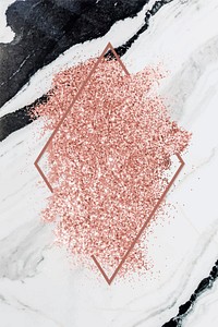 Pink gold glitter with a brownish red rhombus frame on a gray marble background