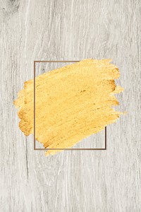 Gold paint with a golden rectangle frame on a beige wood background vector