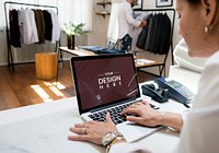 A female business owner is using a laptop