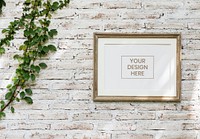 Minimal wooden picture frame on a faded brick wall