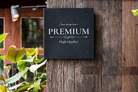 Black signage mockup on a wooden wall