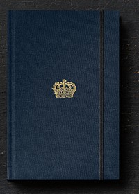 Baroque style crown on a navy blue notebook