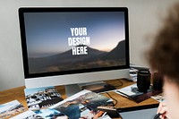 Designer working on a computer screen mockup