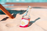 Alcoholic drink bottle in the sand