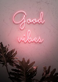 Neon red good vibes on a wall