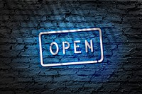 Neon blue open signage on brick wall