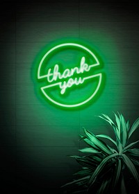 Neon green thank you sign on a wall