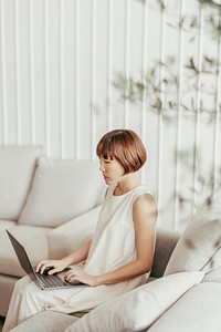 Asian woman working in minimal decor living room