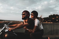 Biker couple riding during sunset