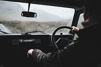 Man driving an old SUV in the Highlands