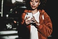 Black woman using phone in downtown