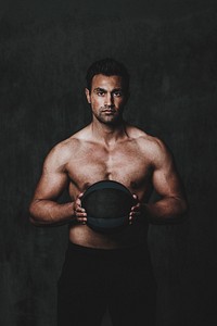 Strong man holding a fitness ball