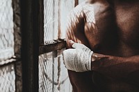 Male boxer putting a strap on his hand