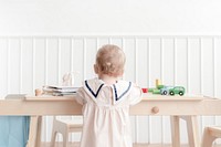 Toddler playing in playroom, rear view