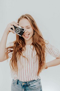 Playful woman with film camera