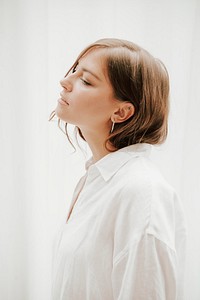 Brown hair woman in a white shirt, profile view