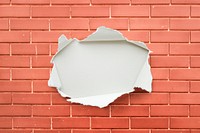 Torn paper mockup on a brick wall