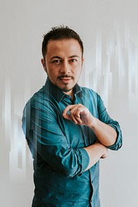 Young businessman standing by white wall