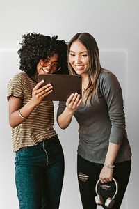 Diverse friends watching an online video clip on a digital tablet mockup