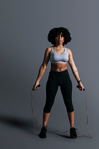 African American woman standing holding skipping rope mockup<br /> 