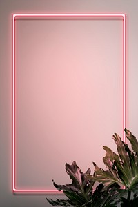 Pink neon frame on a wall with tropical plants mockup design