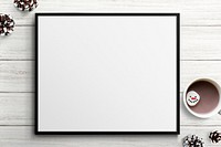 Frame mockup with Christmas decorations on white wooden background