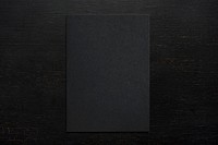 Black paper on a wooden background