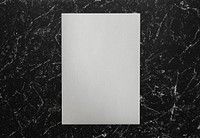 White paper on a black marble background