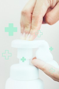 Man cleaning hands with a soap dispenser to prevent Coronavirus