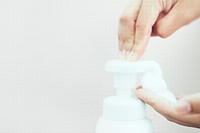 Man cleaning hands with a soap dispenser