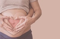 Pregnant woman on a beige background