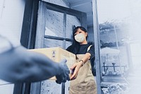 Woman in a face mask receiving a delivery box