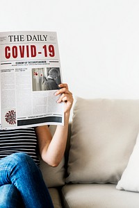 Woman reading coronavirus news from a newspaper